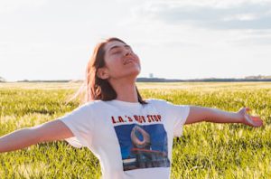 woman standing in green field