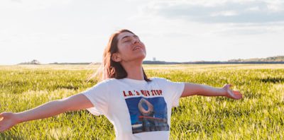 woman standing in green field