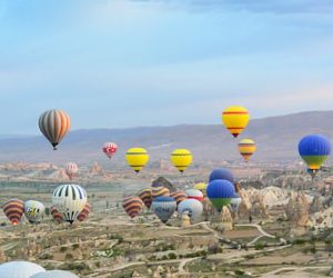 photo of assorted-color air balloon lot in mid air during daytime